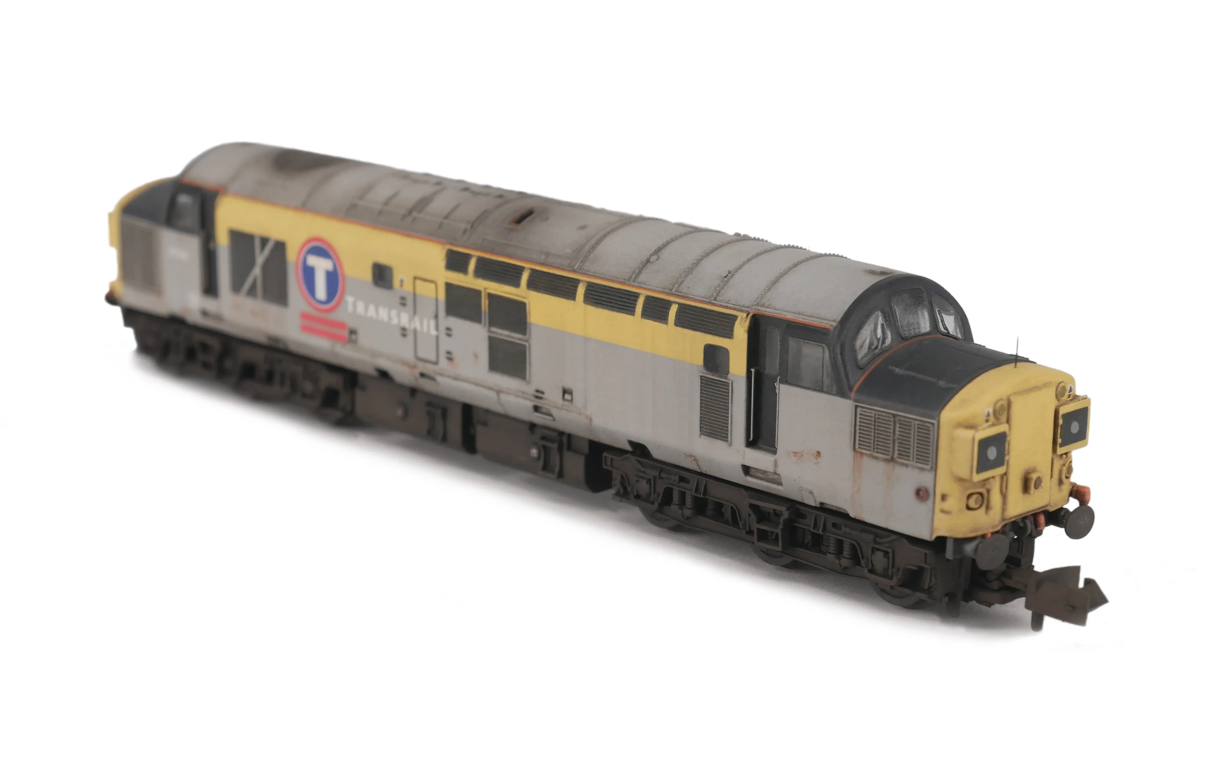 Heavily faded Class 37 in Transrail livery with paint peeling and rust