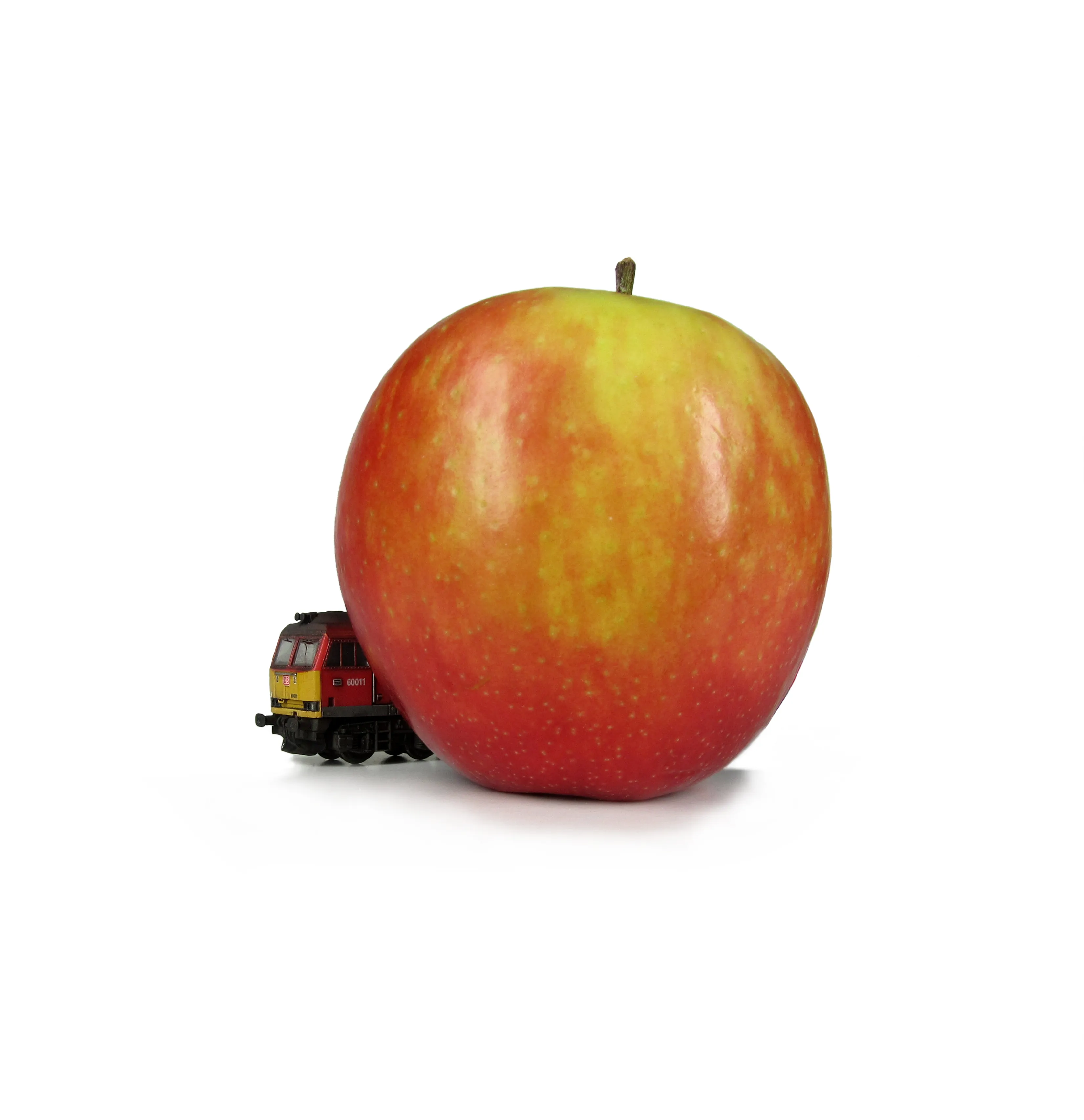 N gauge locomotive next to an apple — demonstrating the tiny scale of these models