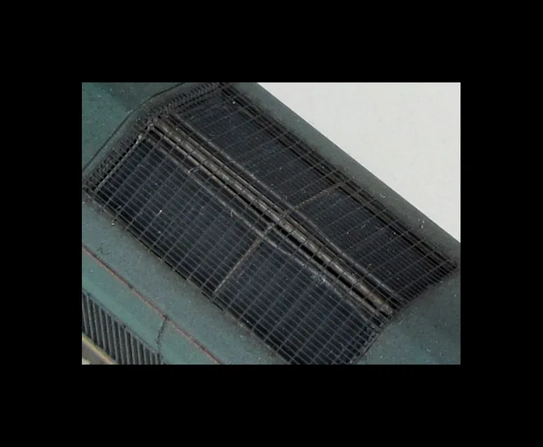 Close up of etched grills with pipes underneath the mesh