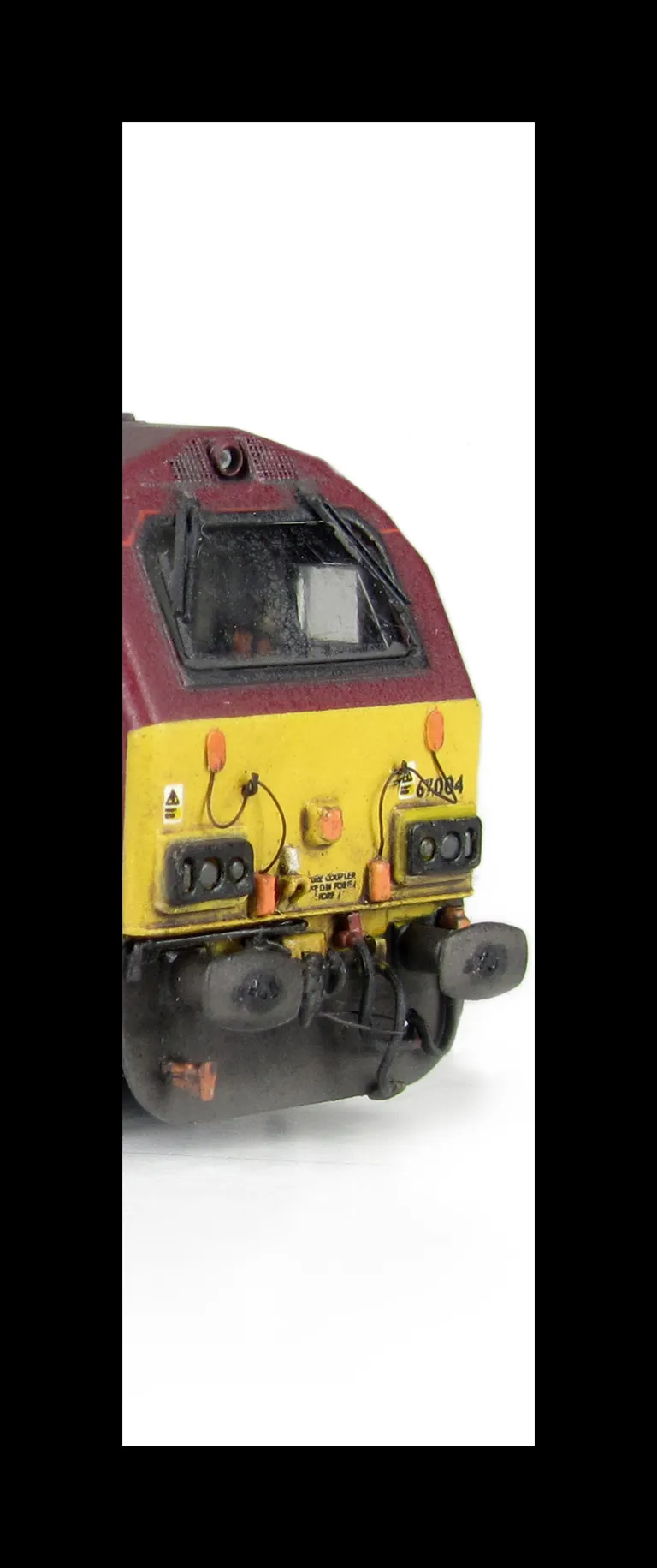 67004 with detailed buffer beam at one end and semi detailed at coupler end, moulded jumper cables replaced with wire versions, renumbered, etched nameplates and driver fitted.