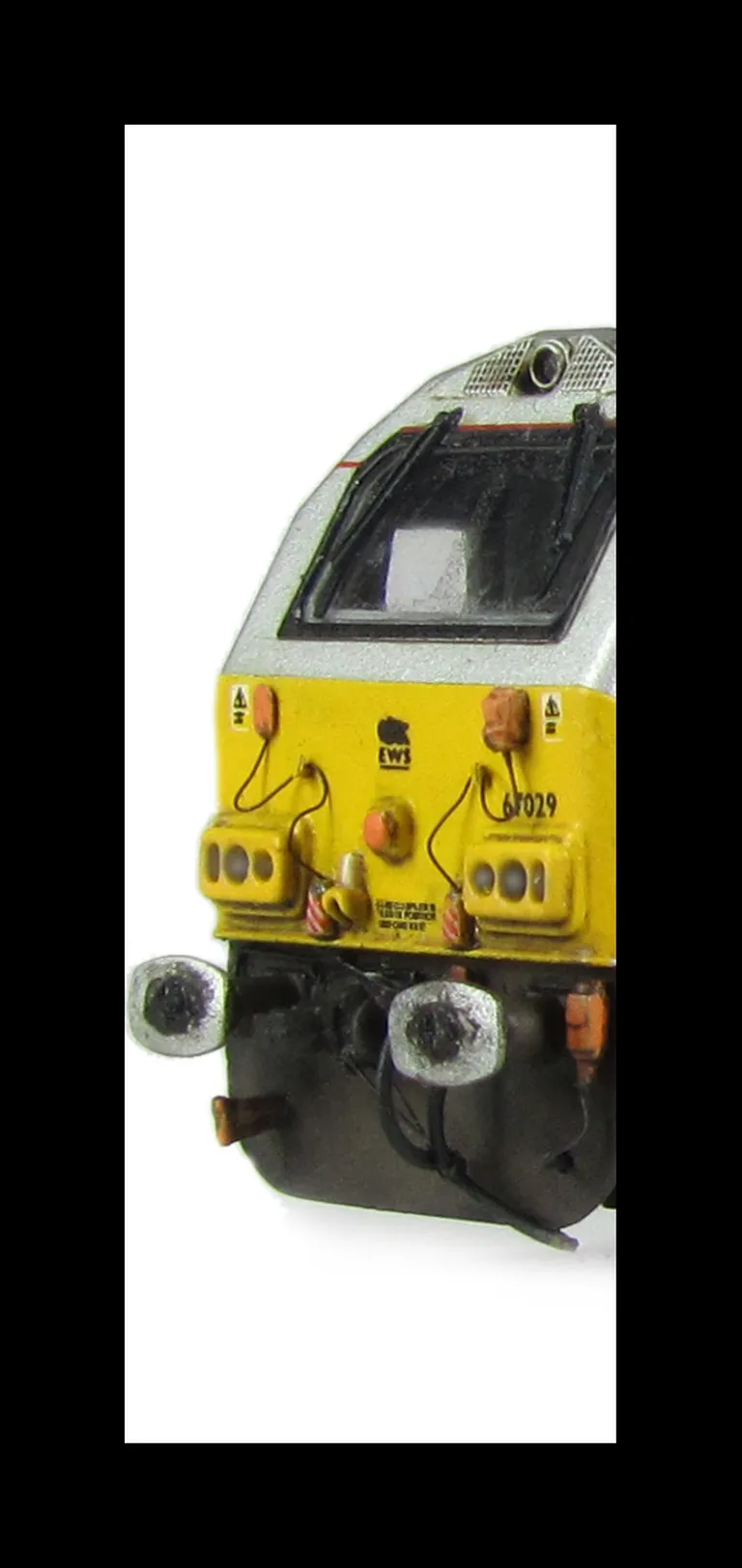 67029 with detailed buffer beam at one end and semi detailed at coupler end, moulded jumper cables replaced with wire versions, etched nameplates and driver fitted.
