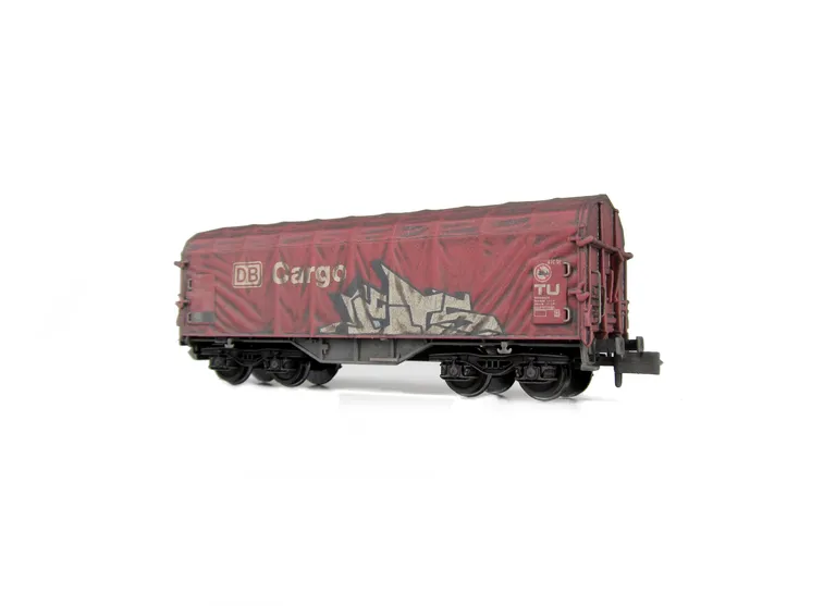 Wagon with faded paintwork and added graffiti.