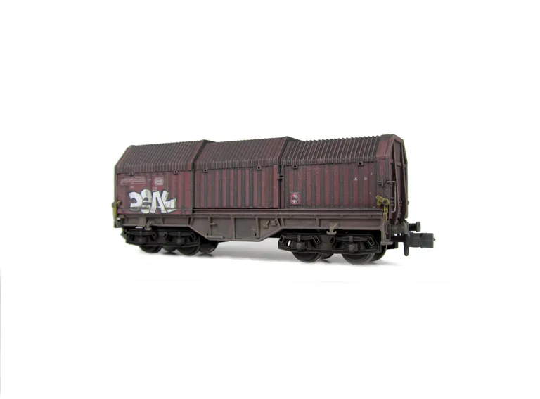 Wagon with faded paintwork and added graffiti.