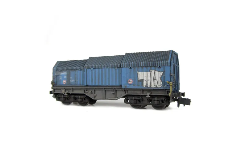 Wagon with faded paintwork and added graffiti.