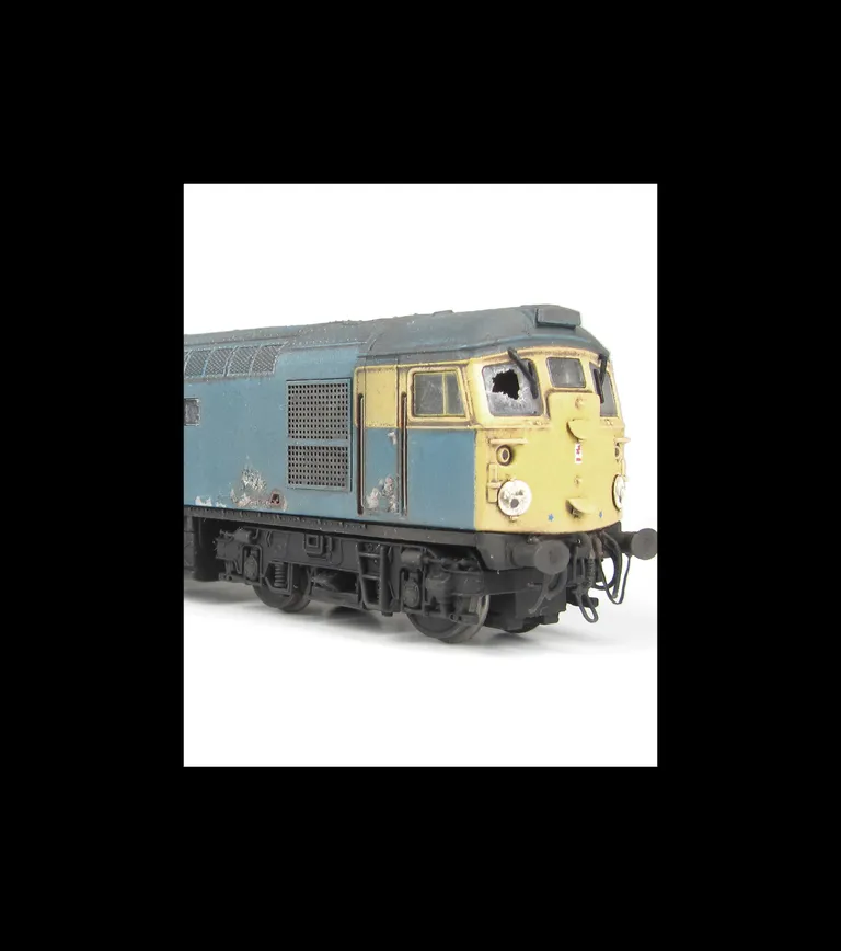 26018 Conversion to disc headcode version representing a loco in it's last days on the scrapline. Full respray into correct faded shades, renumbered, disc catches, special effect of paint peeling and rust patches, broken and boarded over windows, tapered 
