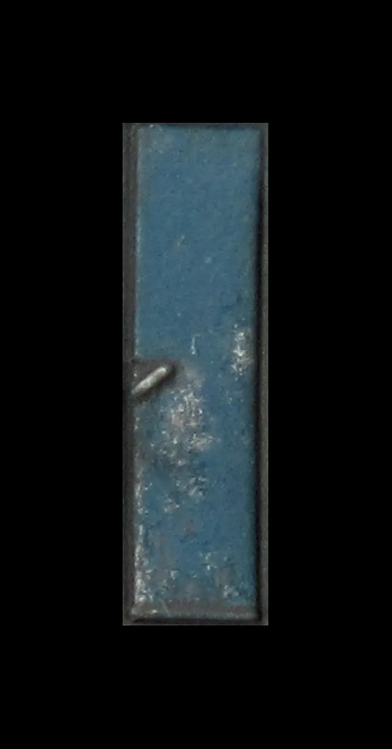 Close up of paint peeling on door showing the bare metal coming through.