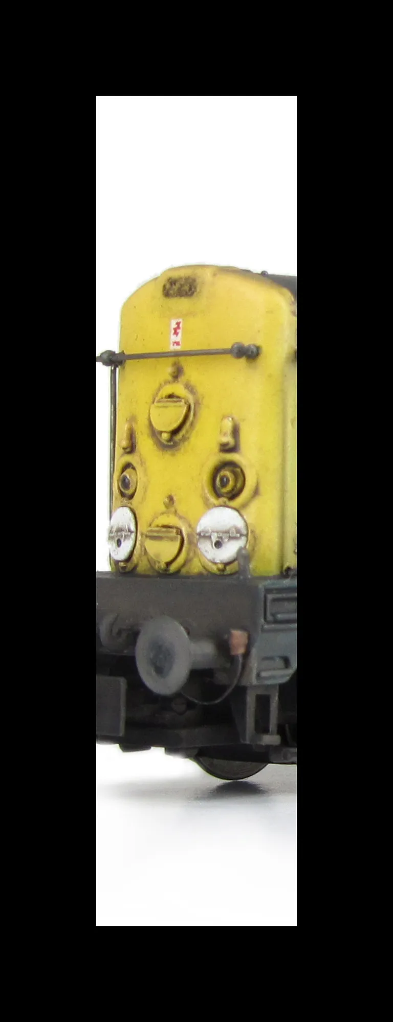 Close up of added fine discs and holes filled with respray of yellow.